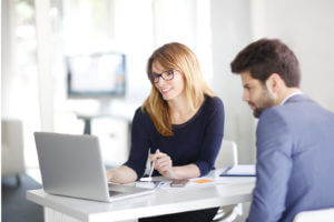 man and woman looking at human resources software