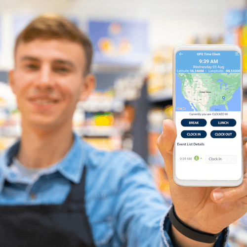 An employee holding a smartphone displaying a payroll software application with GPS tracking