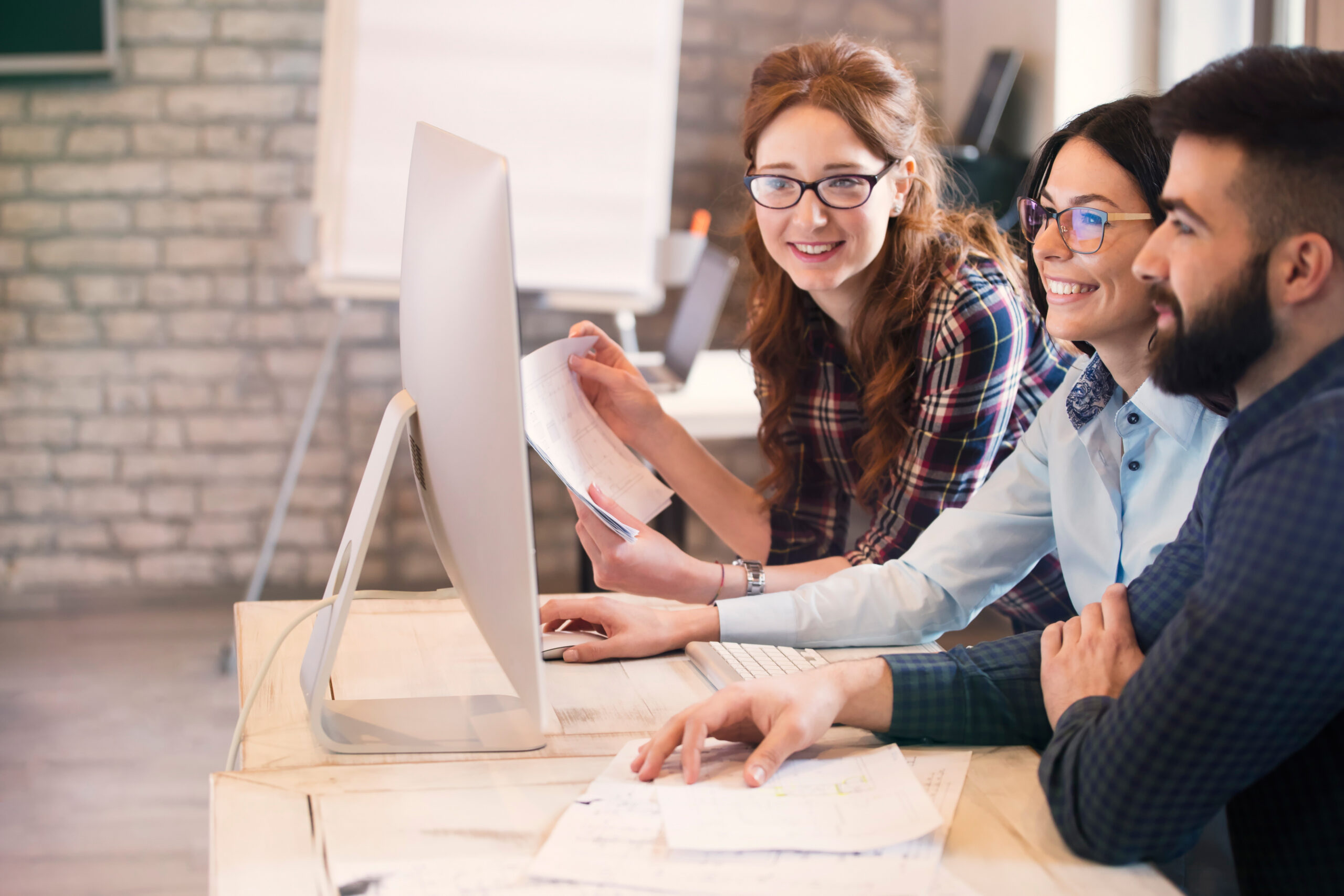 Group of young designers working as team in office